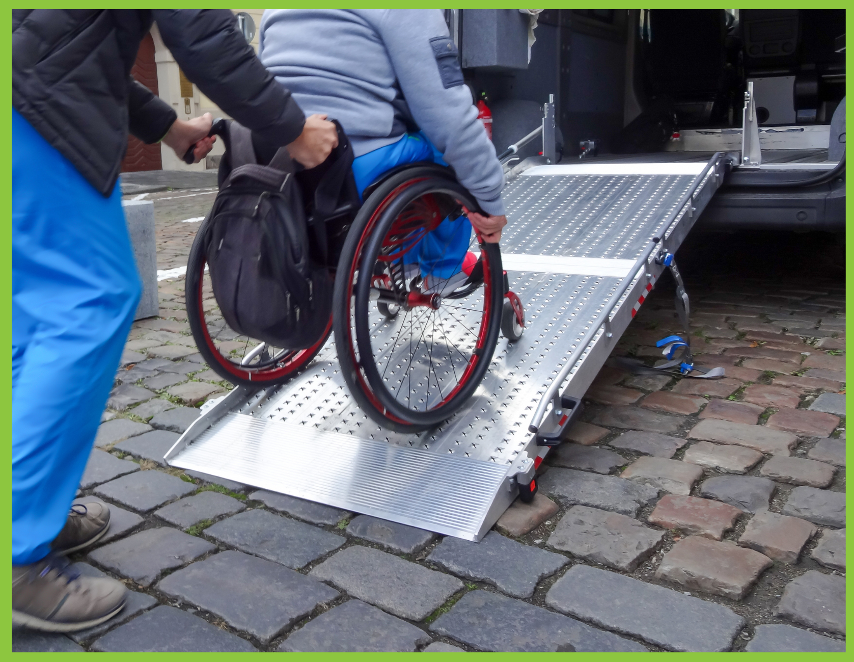 A transportation operator assists an older female into an accessible van 