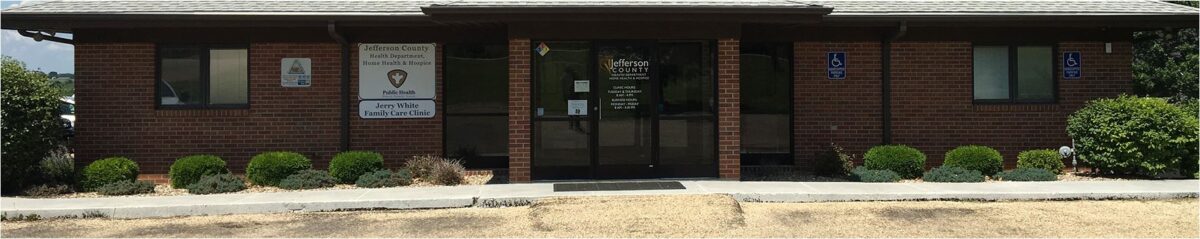 one level brick building with two brick columns and full glass doors and windows at the entrance with a sign that reads Jefferson County Health Department