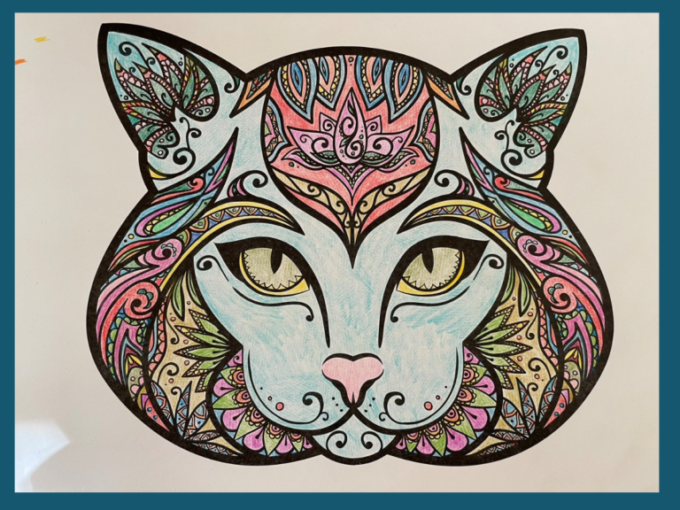 coloring page of mandala style face of a cat face embellished with stylized floral and jewel designs colored in with crayon in muted jewel tones